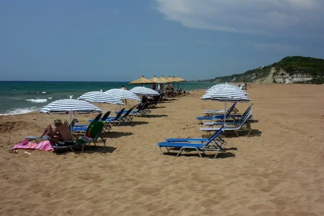 Marathias Beach in Corfu, featuring a sandy shoreline with calm water conditions
