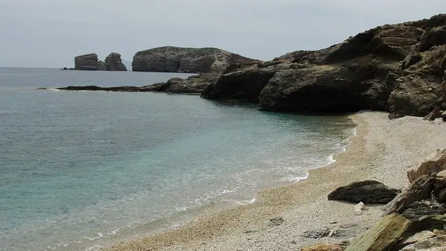 Azalas Beach in Naxos, featuring a mixed shoreline with wavy water conditions